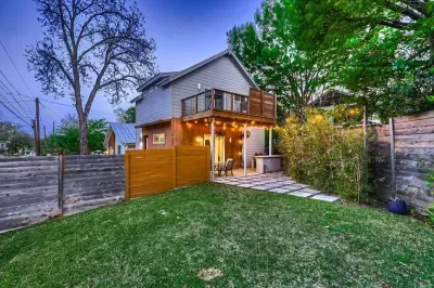 Well-manicured backyard with a variety of flowers and plants, creating a colorful and tranquil retreat.