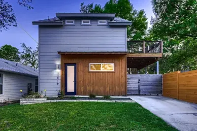 Inviting front entry with lush greenery and a well-maintained lawn.