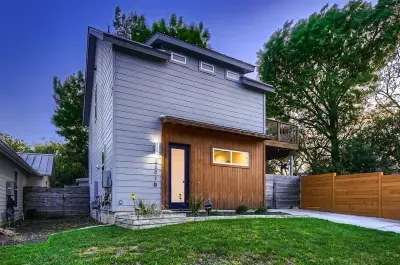 5. Inviting front entry with lush greenery and a well-maintained lawn.