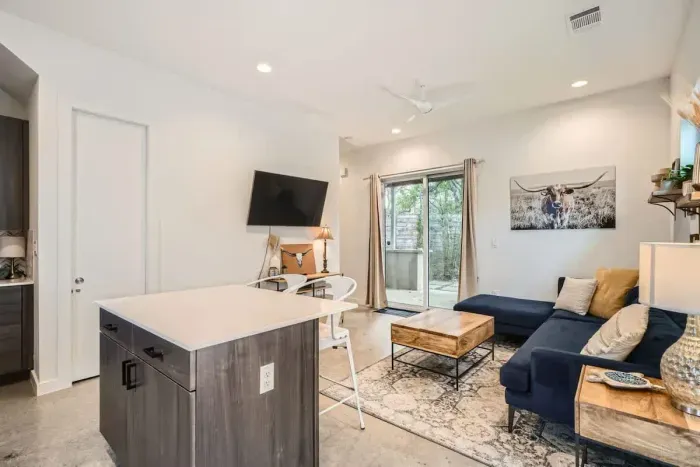 Open-concept living room with seamless flow to the kitchen and dining areas.