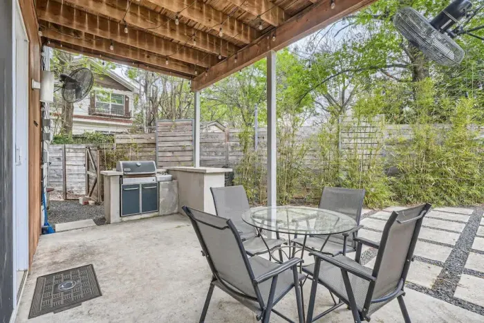 Spacious patio with a dining table and lounge chairs, ideal for outdoor meals and gatherings.