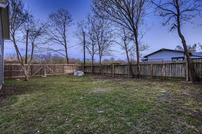 Well-maintained backyard with a variety of trees and shrubs for a natural, private setting.