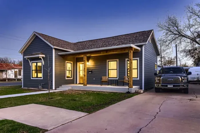 Timeless and elegant home with classic architectural details and a lush front lawn.