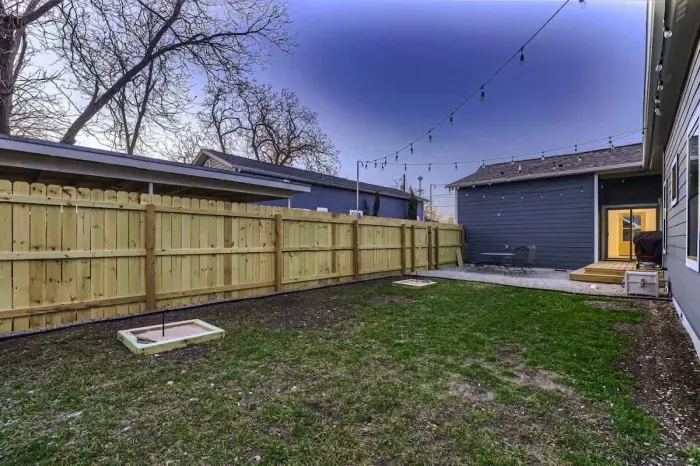 Serene backyard with a patio, ideal for dining al fresco or unwinding under the stars