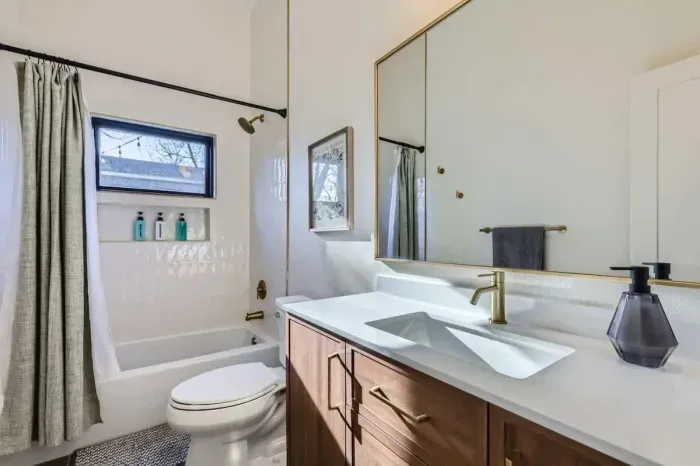 Unwind in our spacious bathroom with modern amenities and a touch of luxury