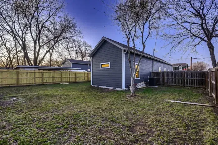 Well-maintained backyard with a variety of trees and shrubs for a natural, private setting.