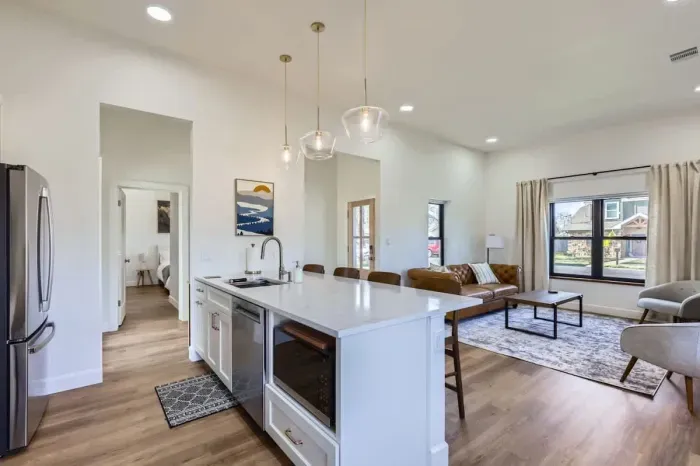 Bright and modern kitchen with stainless steel appliances, perfect for preparing a gourmet meal or quick snacks.