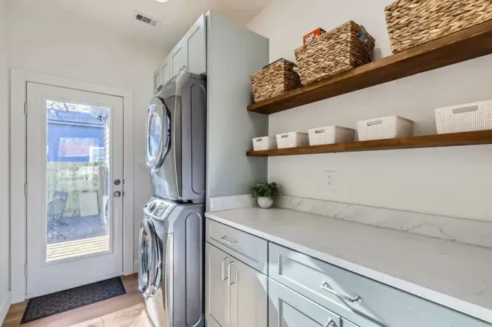 Laundry made easy with a dedicated room, washer, dryer, and everything you need.