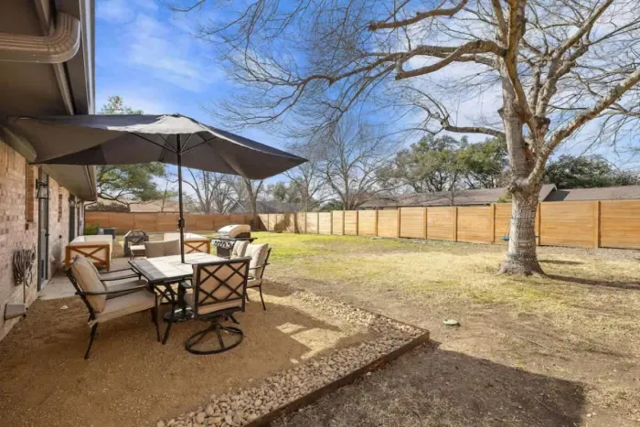 Outdoor patio featuring a built-in grill and comfortable seating, perfect for dining and entertaining. Enjoy meals al fresco or unwind in the fresh air, surrounded by a relaxing atmosphere. This versatile space is ideal for hosting gatherings or simp