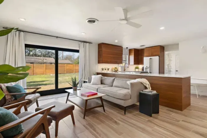 Bright and inviting living room with modern décor, featuring a fully remodeled kitchen and cozy, comfortable furniture. Perfect for relaxation and entertaining, this stylish space offers contemporary design, functionality, and charm. Ideal for creati