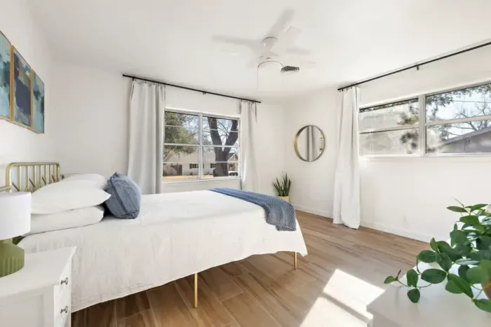 Charming bedroom with crisp white paint, creating a bright and airy atmosphere. The clean, neutral palette offers a serene space for rest and relaxation, easily customizable to suit any style. Perfect for those seeking a peaceful retreat with a timel