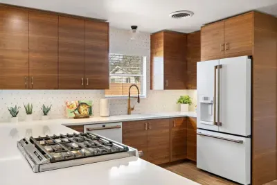 Another angle of the modern kitchen showing ample counter space and storage.