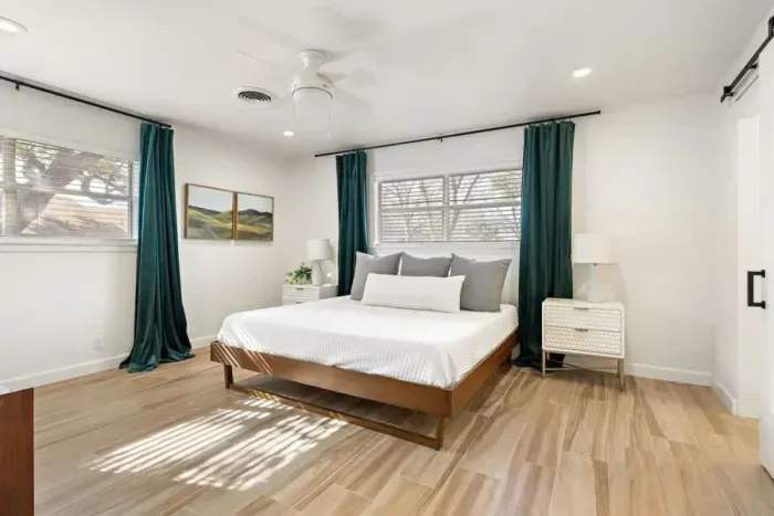 Relax in the spacious primary bedroom featuring a plush queen-sized bed and a private ensuite bathroom. Designed for comfort and convenience, this serene retreat combines cozy elegance with modern amenities, offering the perfect space to unwind and r