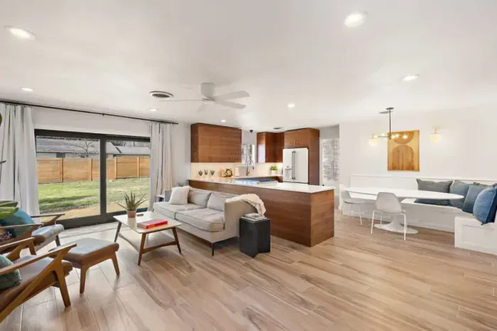 Stunningly renovated, this expansive layout seamlessly flows from the sleek kitchen to the inviting secondary family room. With its open design and abundant natural light, it's an ideal setting for lively conversations and effortless movement.