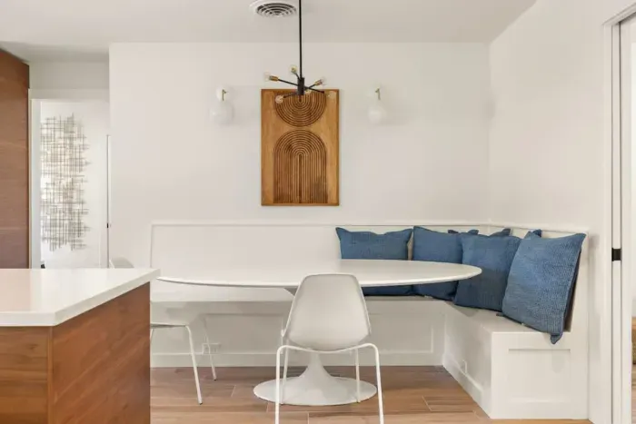 A cozy breakfast and dining nook designed for connection, comfortably seating up to 10 adults. Perfect for group gatherings, game nights, or shared meals, this inviting space blends warmth and functionality, making it an ideal spot for creating memor