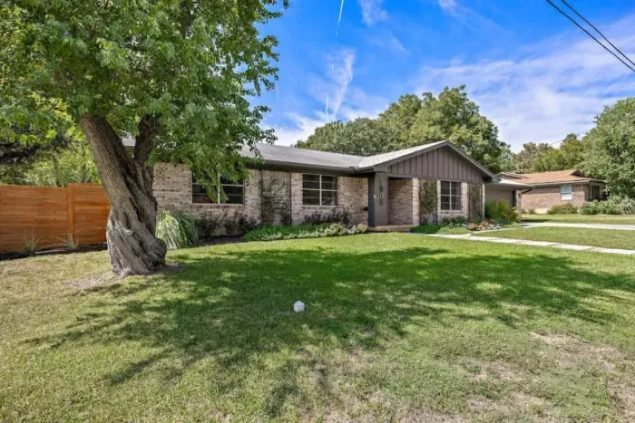 Stunning front exterior with a well-kept lawn and welcoming walkway.