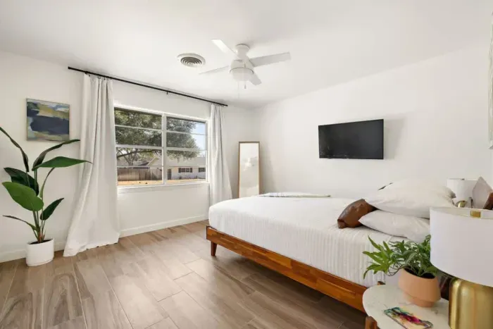 Bedroom 3 features fresh white paint and a large window that fills the room with natural light. The bright, airy atmosphere creates a peaceful retreat, perfect for relaxation. With its simple elegance, this space offers a serene environment, ideal fo