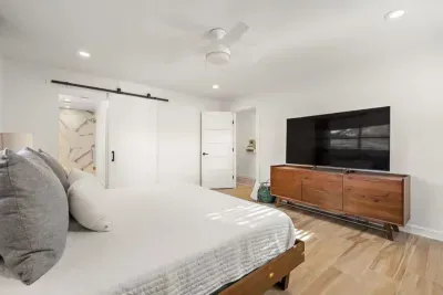 The primary bedroom offers easy access to a private bath with a walk-in, dual-head shower.
