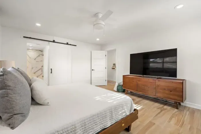 The primary bedroom offers easy access to a private bath with a walk-in, dual-head shower.