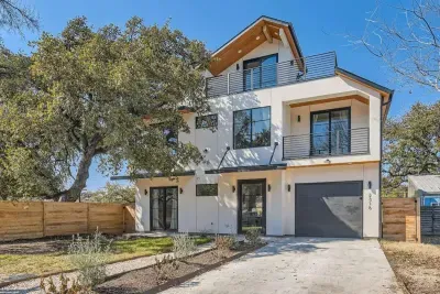 Welcoming entrance with charming curb appeal and lush landscaping.