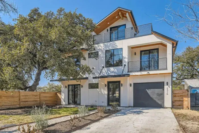 Welcoming entrance with charming curb appeal and lush landscaping.