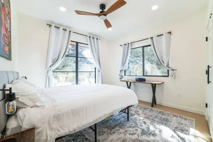 Bright and cheerful bedroom with a large bed and plenty of natural light.