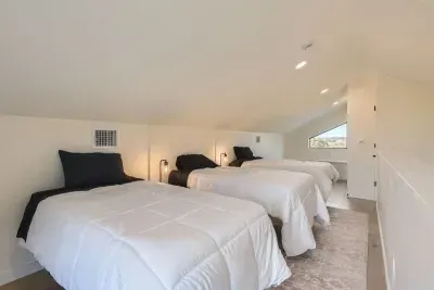 A clean, classic room with 3 single  beds and simple decor, offering a restful night’s sleep and relaxation.