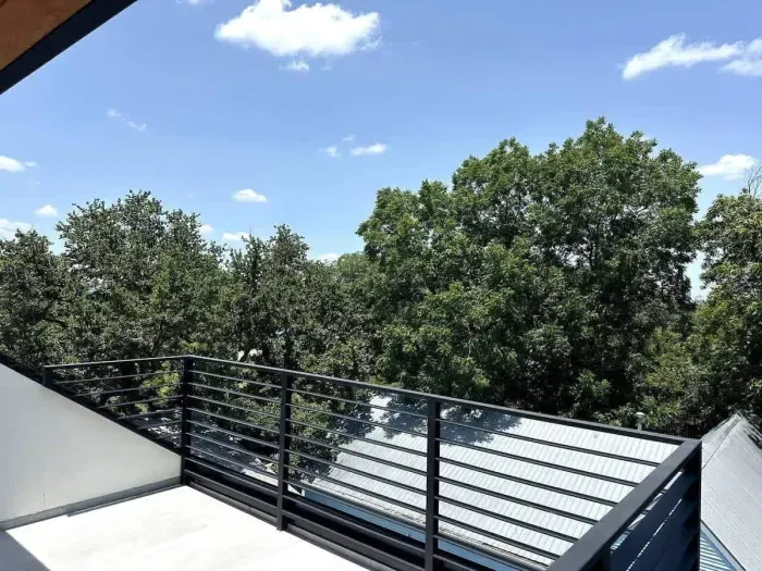 Peaceful patio surrounded by greenery, offering a serene space to relax or entertain.