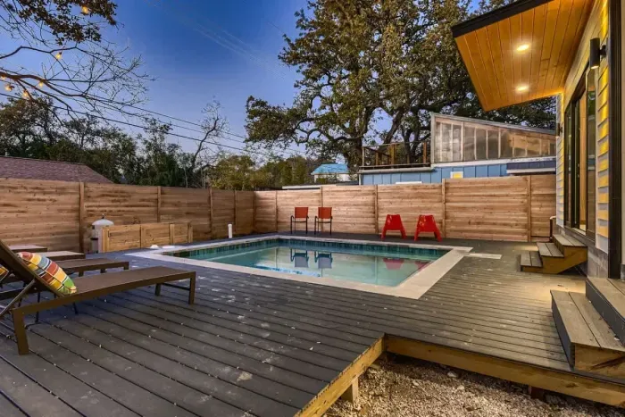 Serenity meets style in our backyard, featuring a stunning pool and cozy seating.