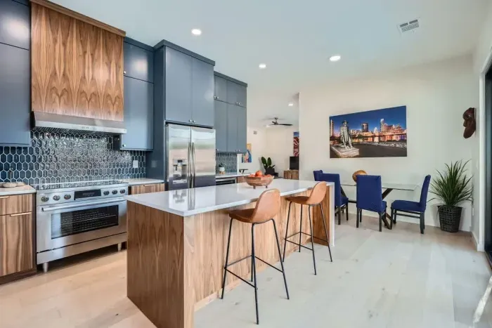 4. This modern kitchen is a harmonious blend of style and functionality, featuring sleek countertops, state-of-the-art appliances, and minimalist cabinetry. A large window or sliding glass doors provide an uninterrupted view of the sparkling pool.