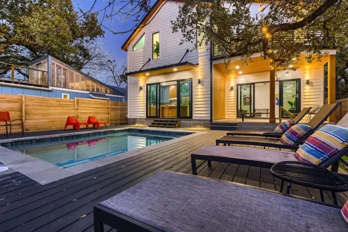 Experience the perfect blend of luxury and comfort at this modern retreat! ✨ With a private pool, expansive deck, and warm ambient lighting, this home sets the stage for relaxation and memorable gatherings, under the stars.