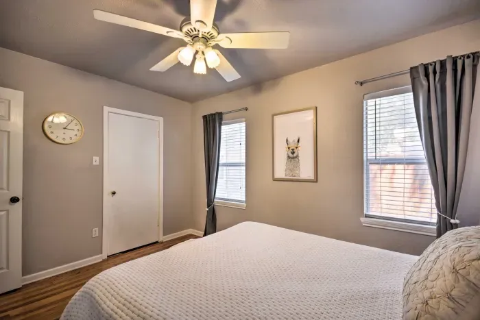 Another bedroom view with natural light and comfortable bedding.