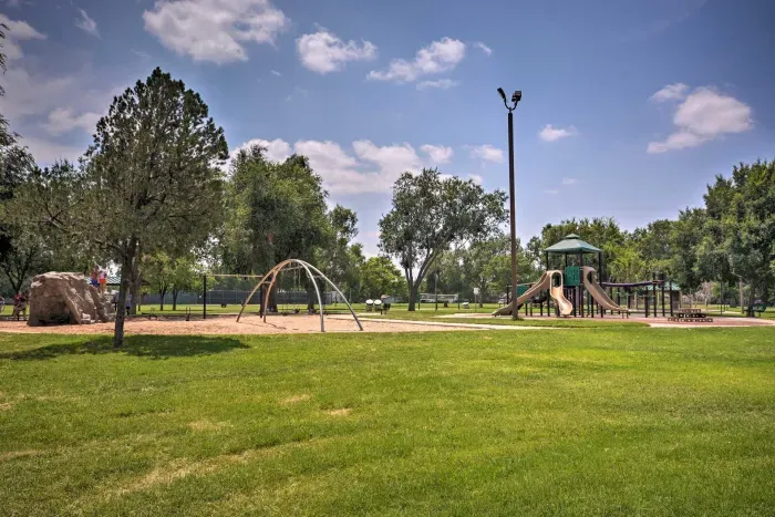 Nearby park with open green space and play area.