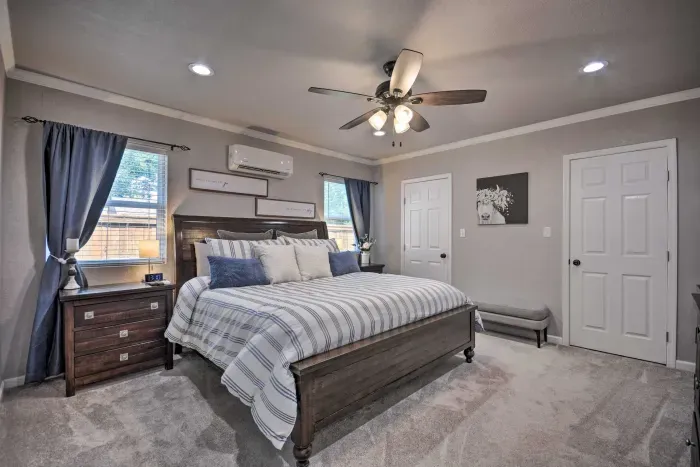 Spacious primary bedroom with king bed, cozy lighting, and modern touches.