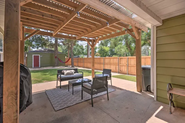 Covered outdoor patio with seating for meals and gatherings.
