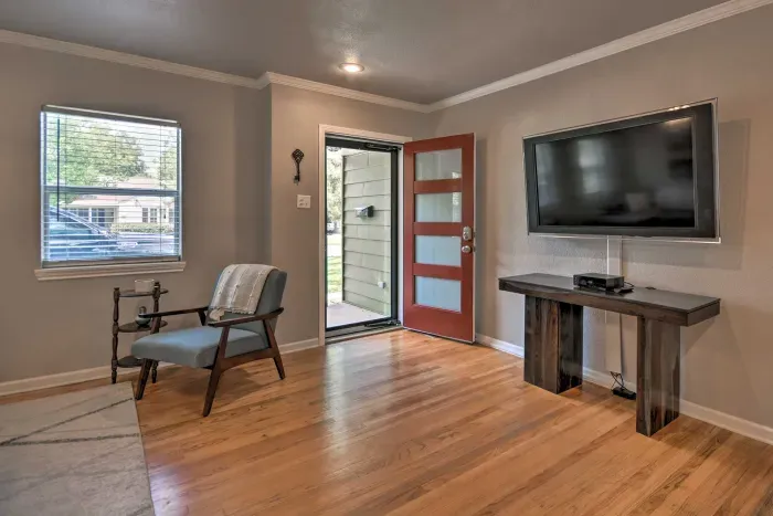 Welcoming entryway with seating and a mounted TV.