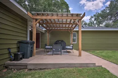 Shaded backyard patio with pergola and outdoor seating.