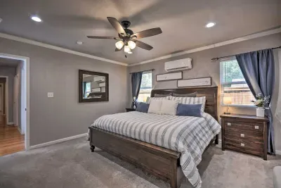 Primary bedroom with king bed, dresser, and cozy lighting.
