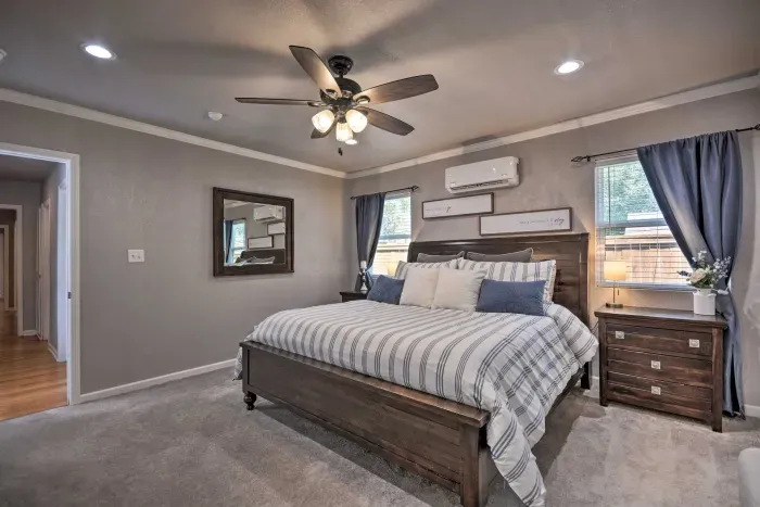 Primary bedroom with king bed, dresser, and cozy lighting.