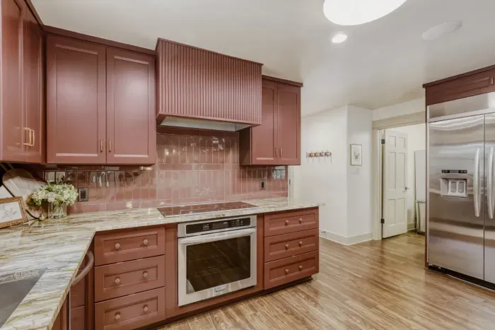 Spacious chef’s kitchen featuring custom finishes, stainless appliances, and plenty of room to cook and connect