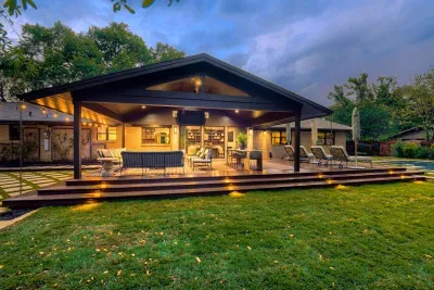 Evenings done right… covered patio living with warm lighting and seamless indoor-outdoor flow