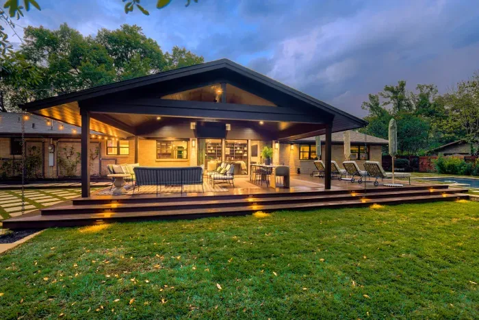 Evenings done right… covered patio living with warm lighting and seamless indoor-outdoor flow