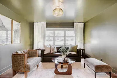 Intimate lounge area with warm lighting and elegant finishes, seamlessly connected to the main living spaces