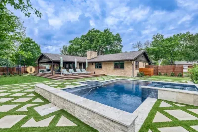 Resort-style backyard with a sparkling pool, spa, and expansive lounge deck, designed for effortless outdoor living