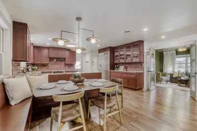 Warm, inviting kitchen with rich cabinetry and a cozy dining nook, perfect for gathering and entertaining
