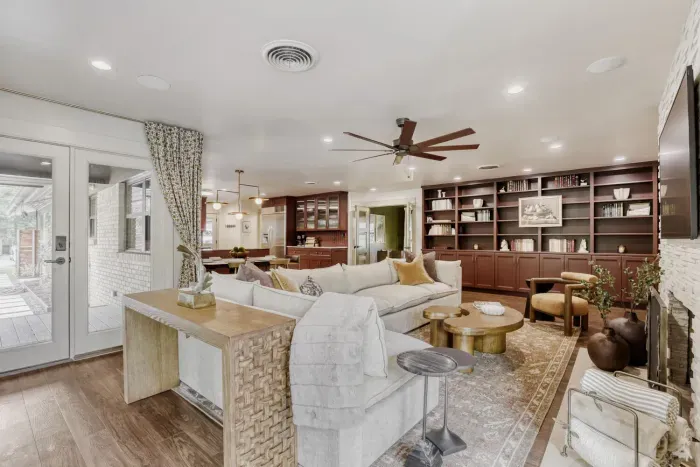 Cozy yet spacious living room with built-in shelving and layered textures, perfect for relaxing or hosting