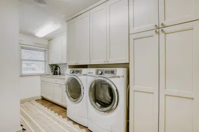 Functional laundry room with abundant cabinetry and counter space, designed to keep everything organized and efficient