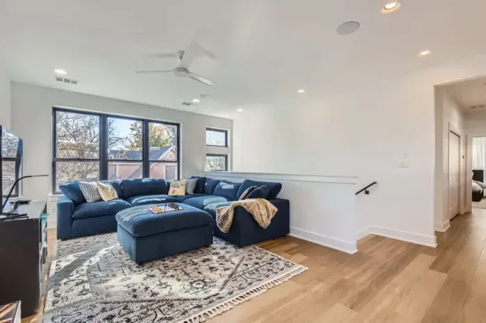 Spacious bonus room with a sectional sofa and a great space for family activities or game nights.