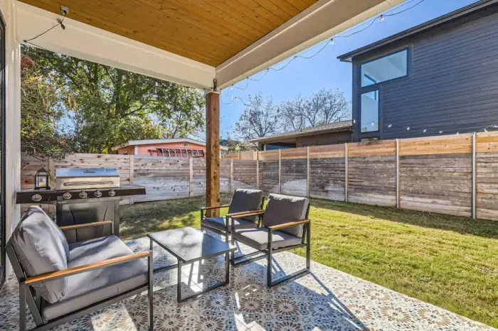 Tranquil patio with a mix of shade and sun, perfect for reading or enjoying a peaceful afternoon.