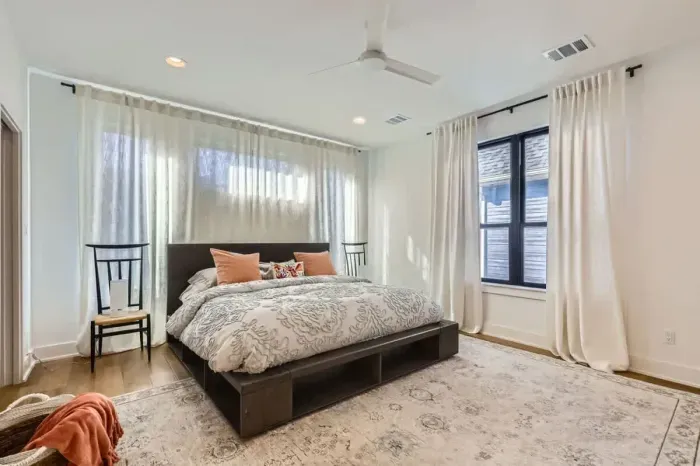 Spacious primary bedroom with a king-sized bed and an en-suite bathroom.